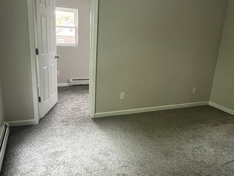 living room with door leading to home offiice or den