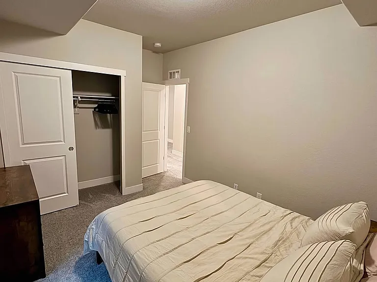 Private Queen Bedroom with Closet, Dresser, Side Tables, Ceiling fan and egress window