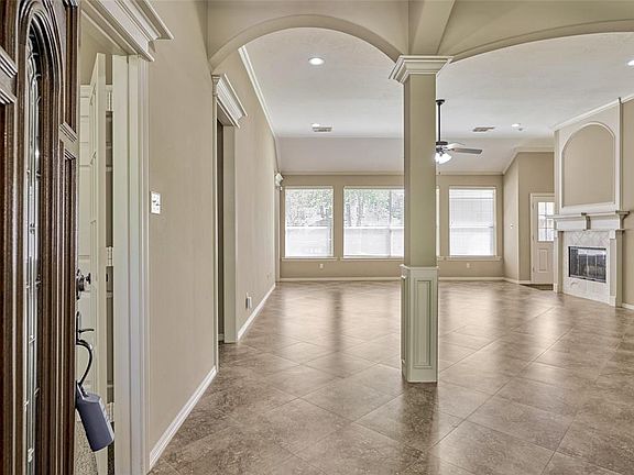 Upon entering the home notice the open floor plan with views through to backyard. Ceramic tile floors in main areas, arch accent details and mill work detail.