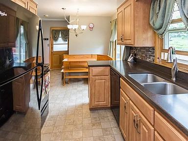 Just off the dinning room, the kitchen features updated cabinets, counter tops, appliances and floor