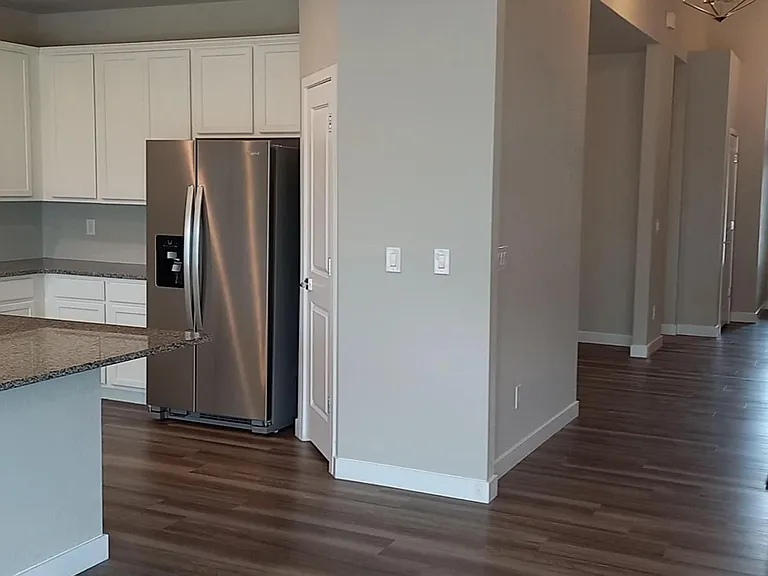 Fridge, pantry in the middle of the photo.