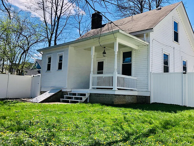 Covered back porch leads to a private fully fenced in flat backyard.