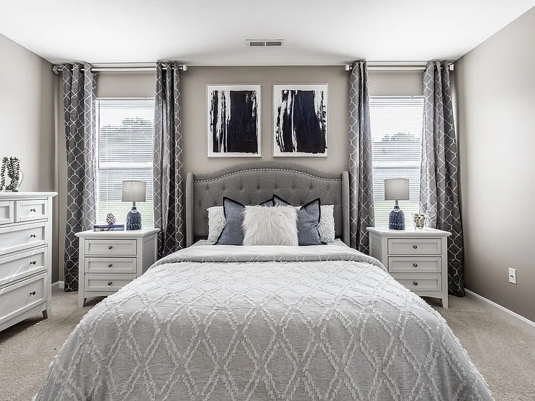 Step into a serene bedroom filled with natural light and thoughtful design, offering a comfortable and functional space to unwind.