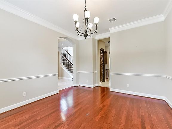 Formal dining room boasts arched windows and classic chair rail.
