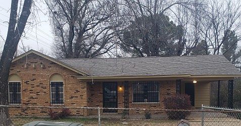 Front view of the house. Entire yard is fenced in.