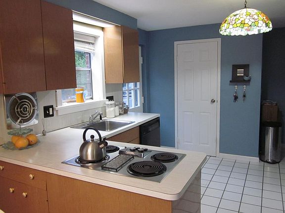 View into kitchen prior to remodel. Half bath behind door