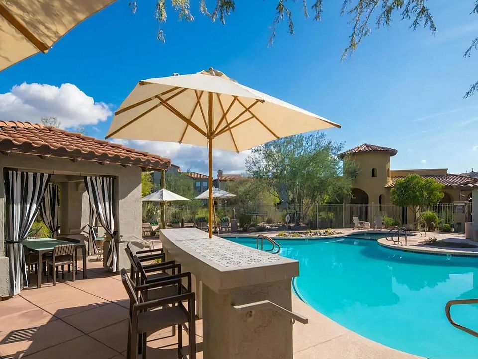 Poolside Dining Area with Bar Seating, Shade Umbrellas, and Cabanas