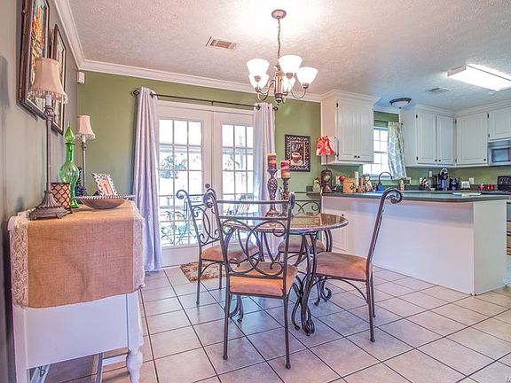 Spacious breakfast room and kitchen. French doors lead to the covered patio and fenced back yard.