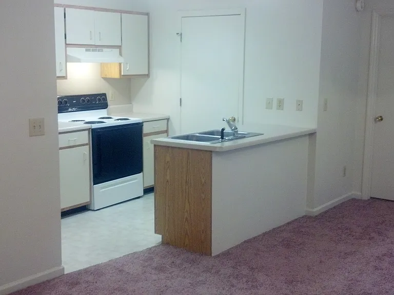 view to kitchen and bar area from living room