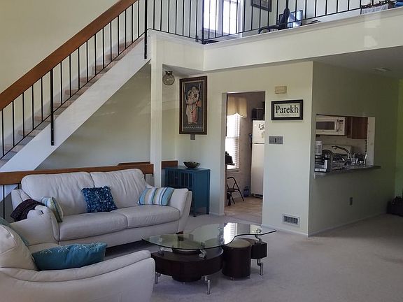 living room showing kitchen and loft upstairs