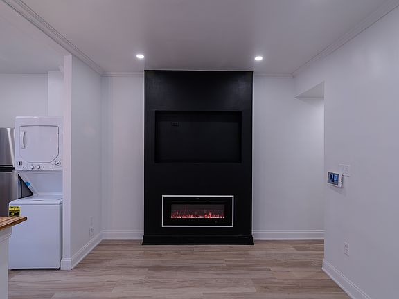 The living room has an area dedicated to mounting the TV.