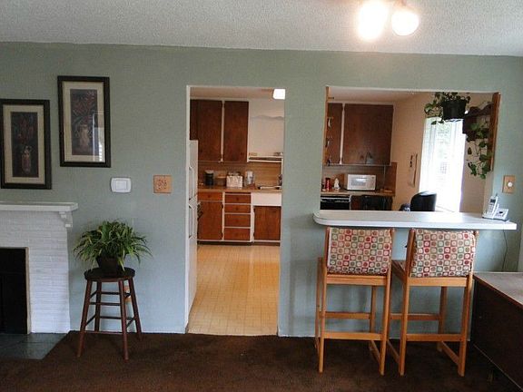 Living room is open to the kitchen with eating bar-pass thru. Hardwood floors under the carpet!