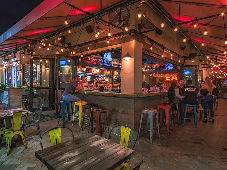 Open-Air Corner Bar with String Lights and Nightlife Vibes