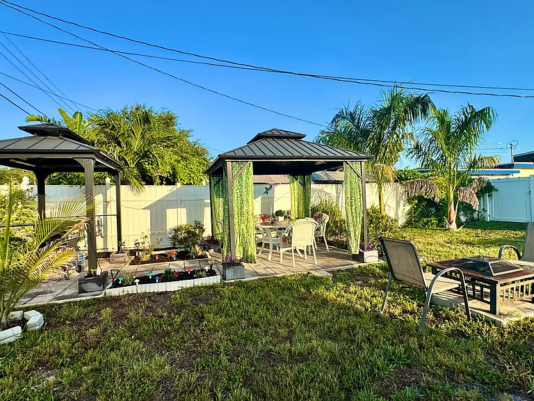 Gazebo with lots of seating. Notice the fire pit?