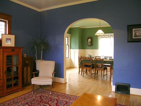 Living room to dining room w/hardwoods & arched doorway.