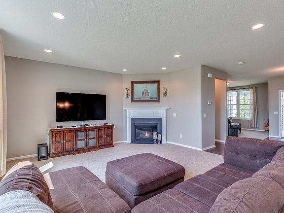 Open living room with gas fireplace and 9-foot ceilings.