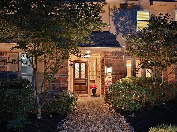 A LOVELY QUAINT ENTRANCE WITH BEAUTIFUL LANDSCAPE AND COVERED PORCH