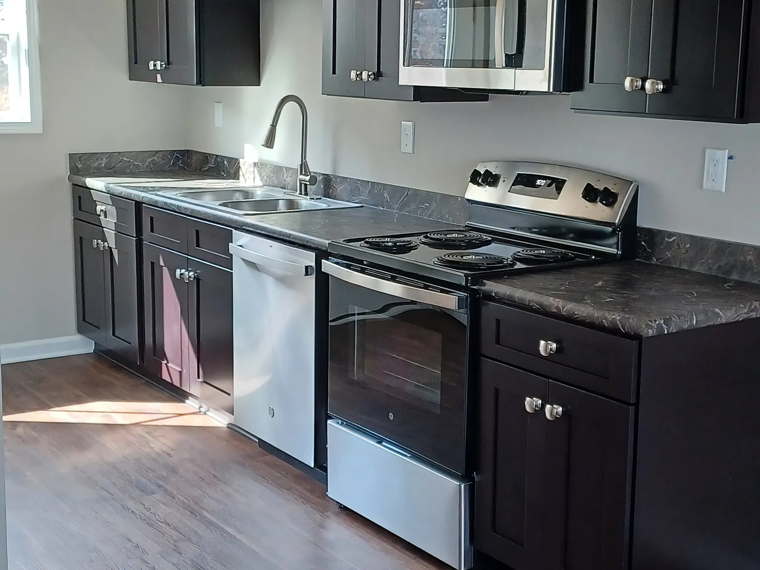 Open kitchen with brand new appliances.