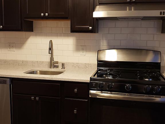 Beautiful, newly renovated kitchen with quartz countertops, maple cabinets, stainless steel appliances and Keystone Pine 6" plank flooring