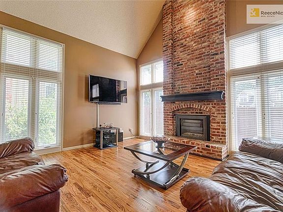 Great room has beautiful hardwood floors, vaulted ceiling w/ceiling fan and floor to ceiling gas fireplace. Home has tons of natural light.