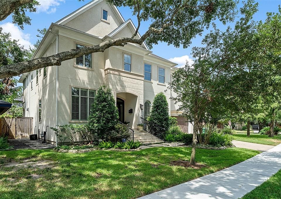 Gorgeous custom built home by Brookstone builders.  Stucco and stone elevated home with lush landscaping.