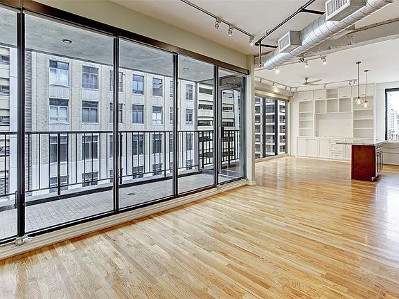 Walls of windows and private balcony are rare features to find in a downtown loft! This home has them both!