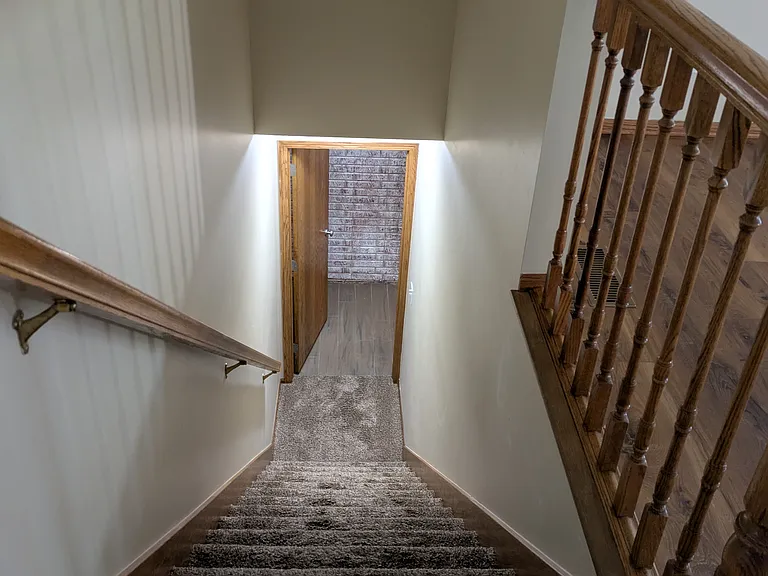 Stairs lead to the lower-level flex room, storage, mechancis, and room for a shop, craftroom, or play area.