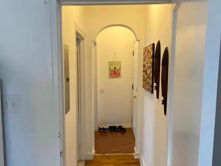 Hallway from living area back to the bathroom, bedroom, & front door.