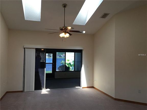 Formal Living Room with Skylights and Sliders leading to Enclosed Lanai