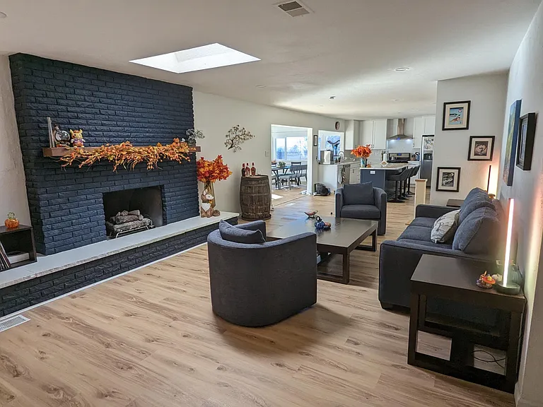 Living room, perspective from end of entryway hall. Brick is black. *pictured furniture to show depth and dimension, furniture not included
