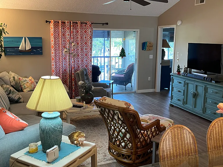 Large living room with vaulted ceiling and open floor plan and sliders that open to a spacious Lani.