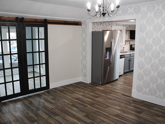 Sun room with barn doors and dining room