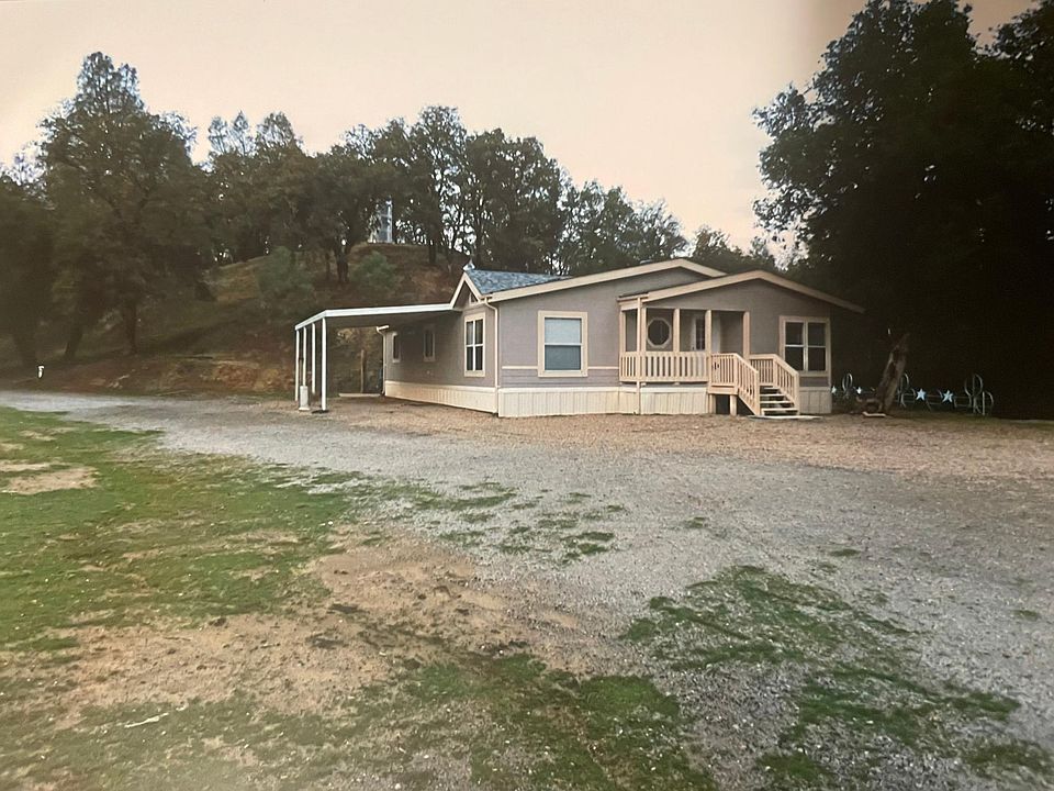 Front of house and car port. Picture taken where 1000 sq. ft greenhouse sits.