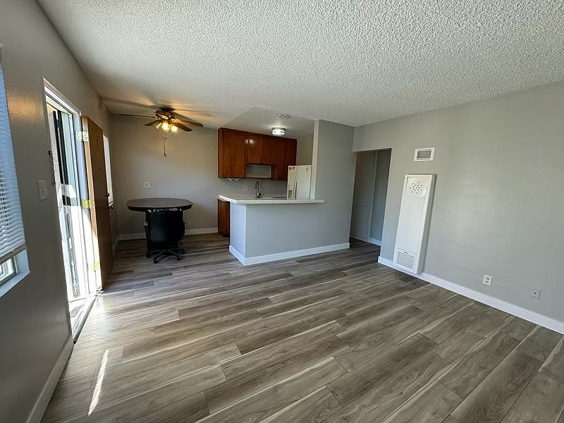 Living room and kitchen with new vinyl plank flooring and new paint