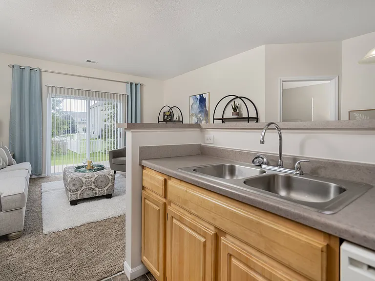 A sunlit kitchen with modern amenities, perfect for cooking and gathering with family.