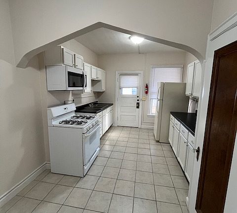 Kitchen view coming from inside apartment. Great view of the arch. New microwave, cabinets, countertops and lighting.