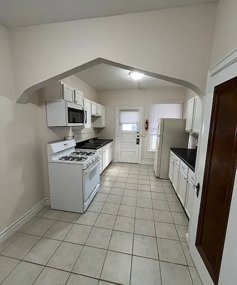 Kitchen view coming from inside apartment. Great view of the arch. New microwave, cabinets, countertops and lighting.