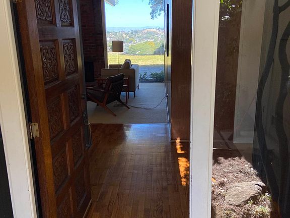 The entryway reveals a floor to ceiling view of the adjacent open space and Sugarloaf Mountain.