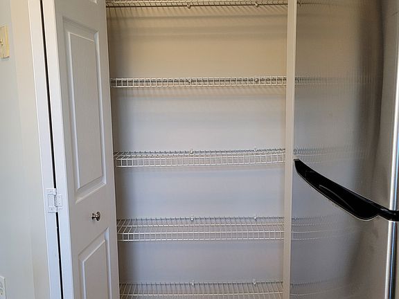 Kitchen has 5 shelf pantry for storage
