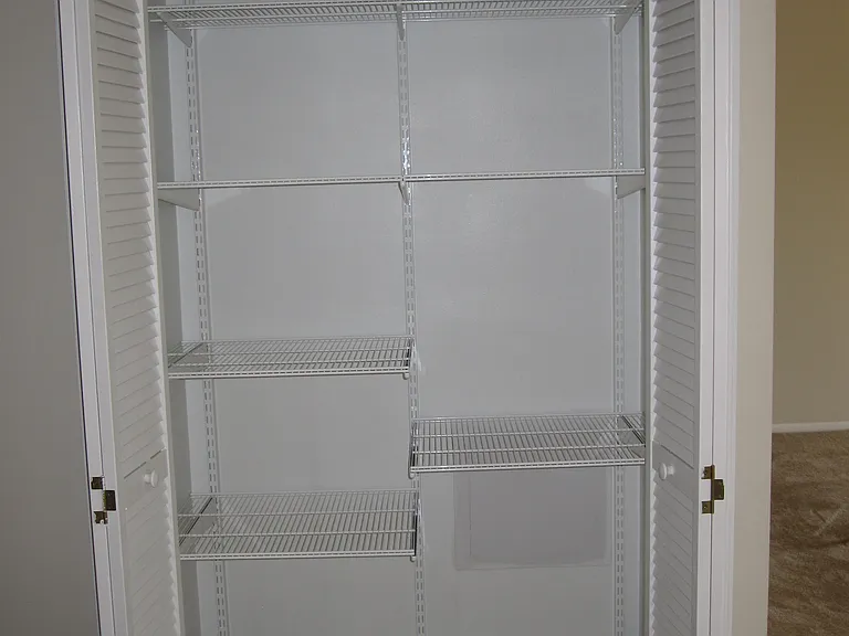 adjustable shelves inside hall closet - bonus closet