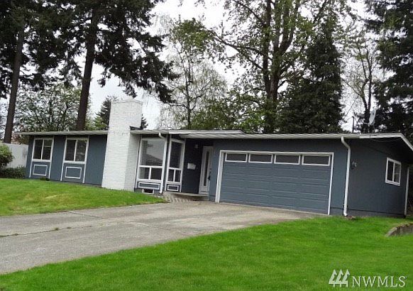 Mid century modern home set back to allow for extra large rolling front lawn.