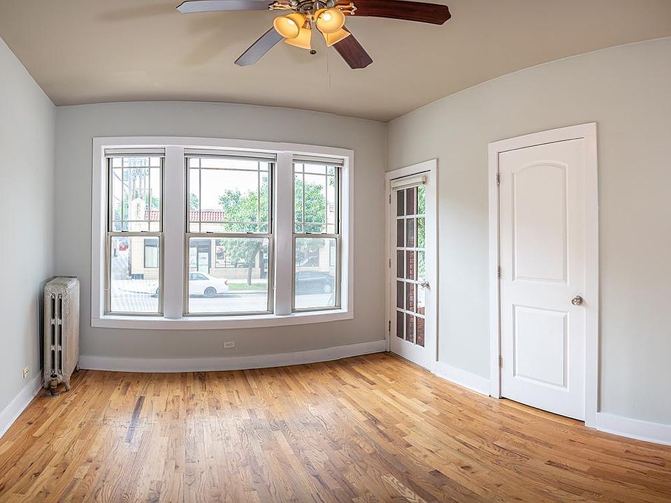 Off the comfortably sized living room, with ceiling fan and lighting, walk through a lovely French door to a large balcony to add to your living space.