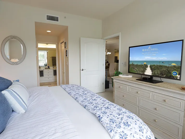 Master Bedroom overlooks the golf course and features a king-size bed, TV, two walk-in closets, a sitting area, and an ensuite bathroom