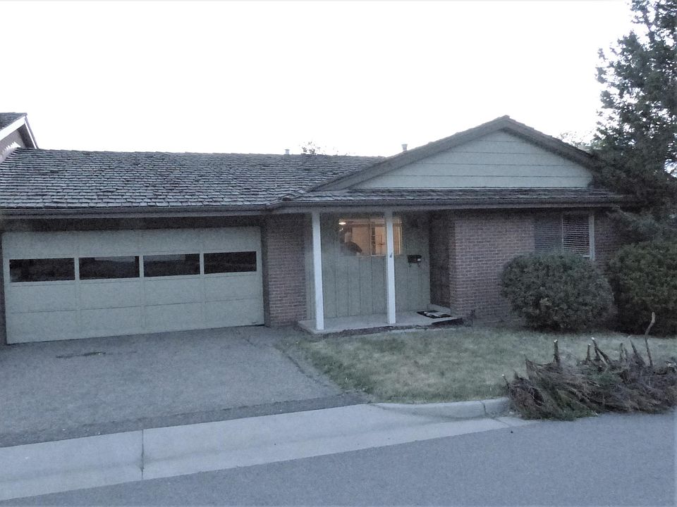 4605 S. Akron front porch with 2 car garage and 2 private parking spaces in front.