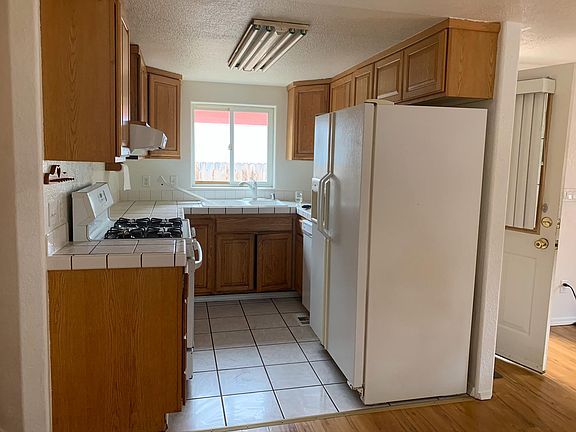 Functional kitchen with plenty of cupboard space and easy-care tile flooring.