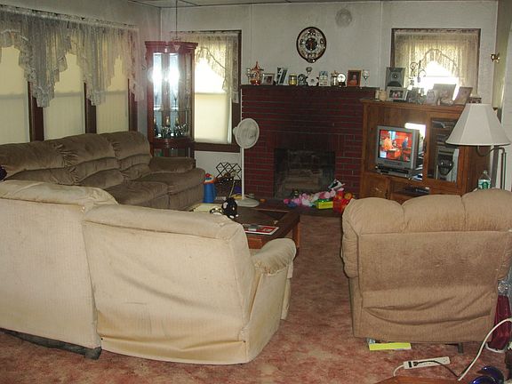 Another room with a wall of windows and access to the front sun porch.