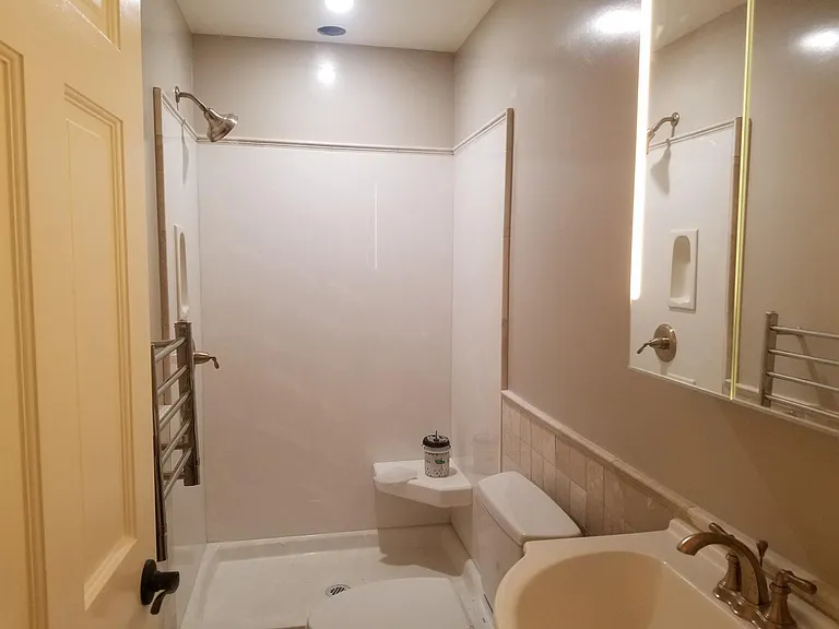 2nd bath with marble tile and shower stall. Dula flush toilets, heated towel bar. Lighted medicine cabinet.