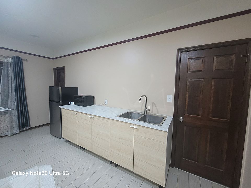 Full Kitchenet with Fridge, Microwave, Induction stove, ample of storage, few utensils. Dining table.