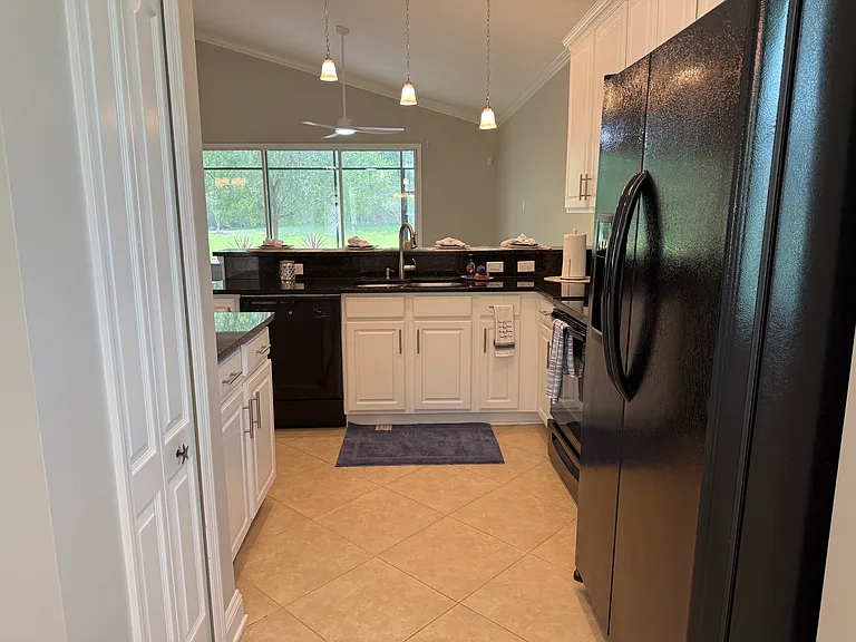 View from Breakfast Nook/Cafe to kitchen. Pantry door on the left.