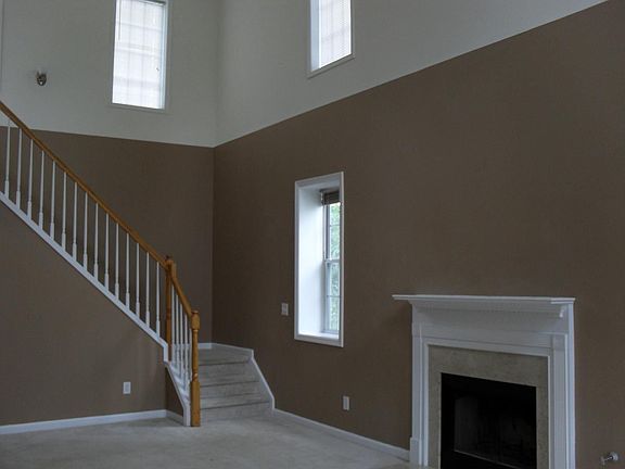 2 story living room with marble fireplace